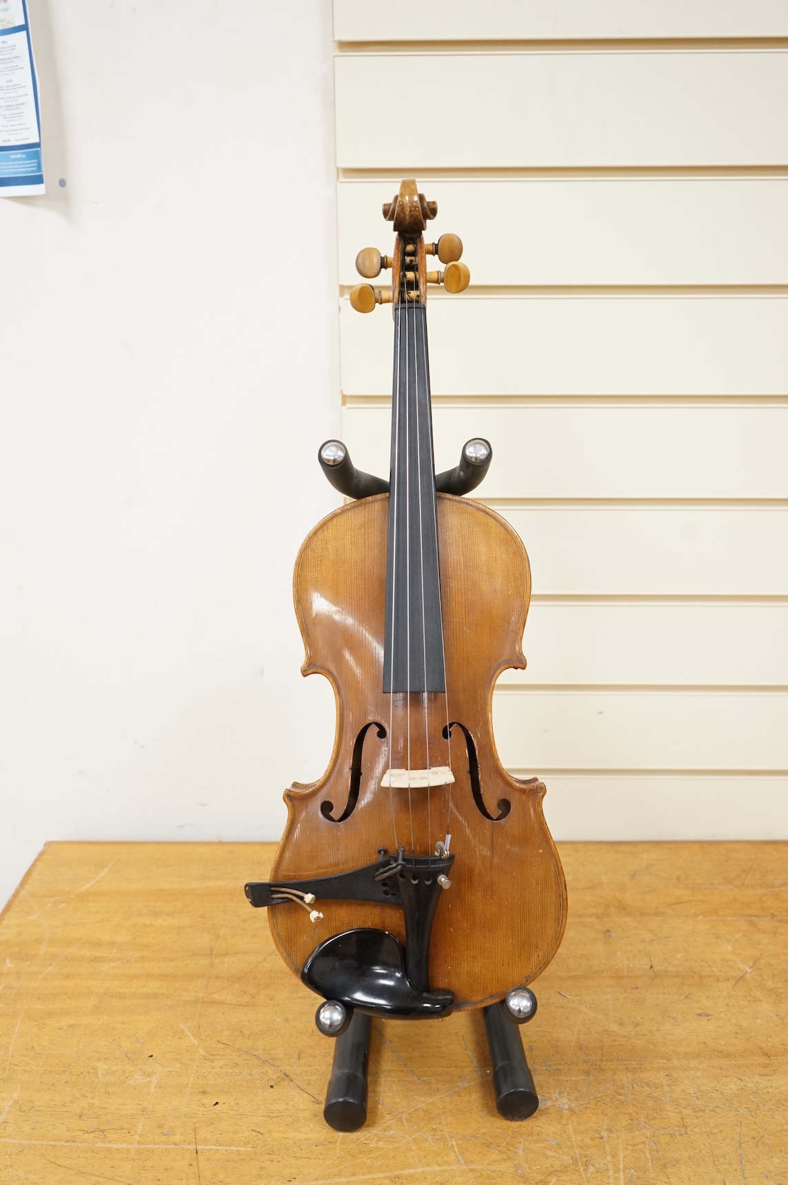 Five cased 20th century violins, including; a German violin, two Czech violins, a three-quarter size violin with a label for Bienfait, and a Romanian quarter size violin, all in cases or the remains of cases.